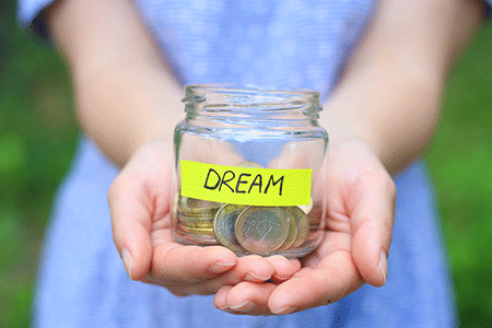 girl-in-blue-dress,-hands-holding-glass-jar-bank-with-dream-note-yellow-sticker-listing.gif