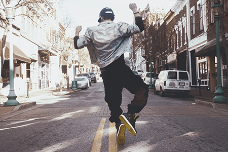 man-jumping-in-the-middle-of-the-street-during-daytime-listing