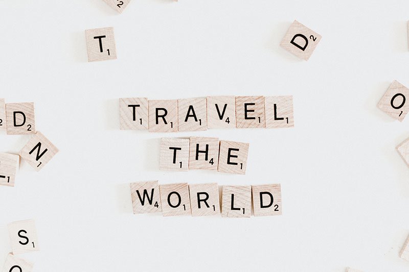 Scrabble letters spelling out &#39;travel the world&#39;