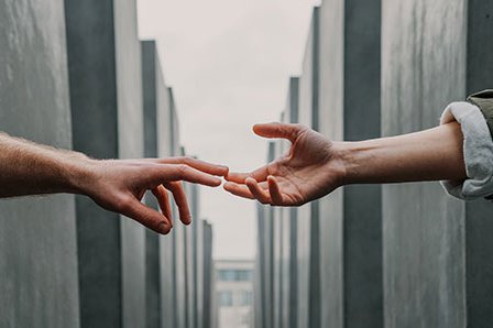 two hands reaching out to each other byToa Heftiba-Unsplash