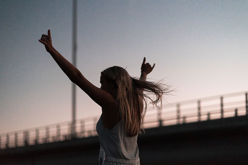 woman raising hands above her