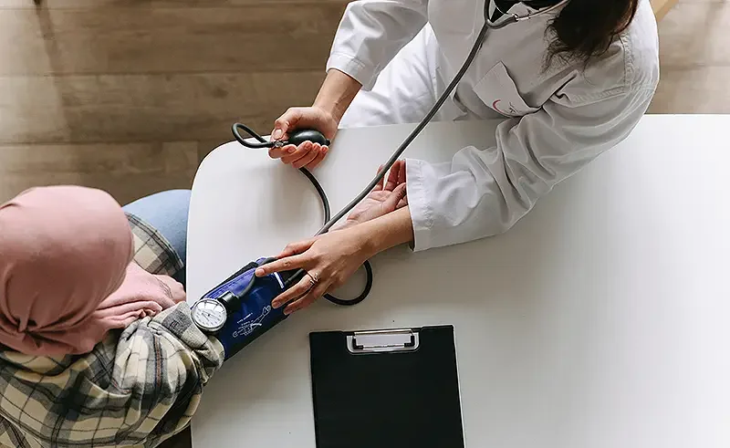 woman being checked by a doctor