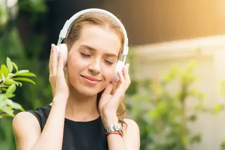 woman listening to music on headphones - listing.webp