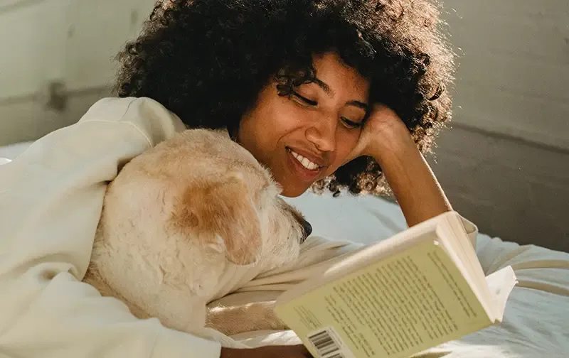 Woman reading a book with her dog 2