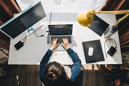 woman working at a desk on laptop at home