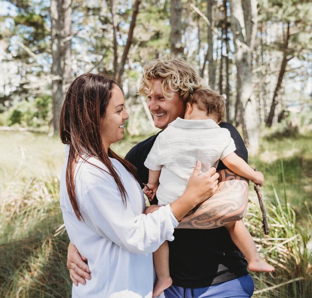 Young kiwi family embracing in nature